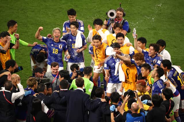 Japan players celebrate the 2-1 win over Germany (Getty Images)