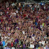 Fans cheer and do the wave before a preseason friendly match between Barcelona and Real Madrid. (Getty Images)