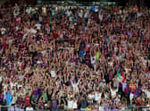Fans cheer and do the wave before a preseason friendly match between Barcelona and Real Madrid. (Getty Images)