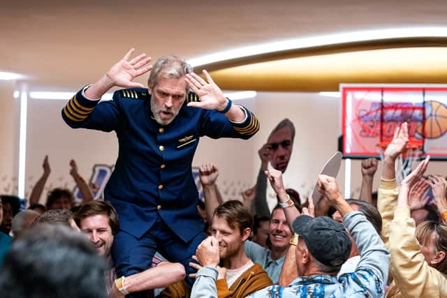 Hugh Laurie as Captain Ryan Clark, being carried on the shoulders of the Avenue 5 passengers (Credit: HBO)