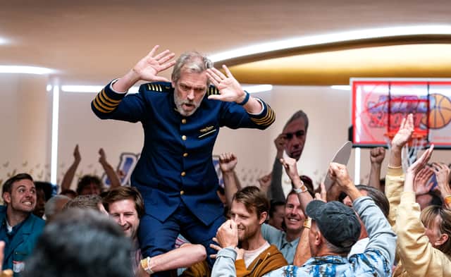 Hugh Laurie as Captain Ryan Clark, being carried on the shoulders of the Avenue 5 passengers (Credit: HBO)