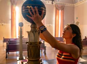 Lisette Olivera as Jess Valenzuela in National Treasure: Edge of History, reaching to grab an artefact (Credit: Disney/Brian Roedel)
