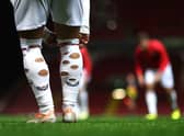 A footballer with holes in his socks. (Photo by Alex Pantling/Getty Images)