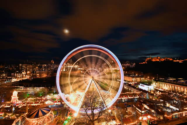 EDINBURGH, SCOTLAND - DECEMBER 07:  Members of the public enjoy a ride on a ferris wheel on December 7, 2016 in Edinburgh, Scotland. The Christmas Market is situated in Princes Street Gardens in Edinburgh and has a number of stalls and attractions such as an ice rink, carousel, Big Wheel, and has been open since late November and runs until January 7, 2017.  (Photo by Jeff J Mitchell/Getty Images)