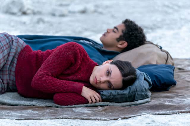 Dafne Keen as Lyra Belaqua and Will Parry as Amir Wilson in His Dark Materials, lying next to each other on the ground (Credit: Bad Wolf/BBC/HBO/Nick Wall)