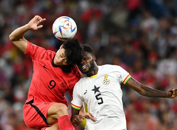 <p>Guesung Cho of Korea Republic competes for a header against Thomas Partey. Credit: Claudio Villa/Getty Images</p>