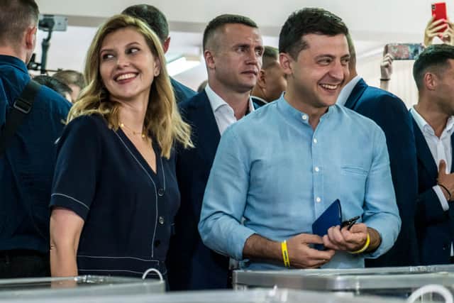 Olena Zelenska (L) and her husband, Ukrainian President Volodymyr Zelenskiy (R), cast their ballots in parliamentary elections on July 21, 2019 in Kiev, Ukraine. Zelenskiy used his inaugural speech two months ago to call for snap elections, and is hoping that his Servant of the People party will win an outright majority of seats in the Verkhovna Rada, Ukraine's parliament. (Photo by Brendan Hoffman/Getty Images)