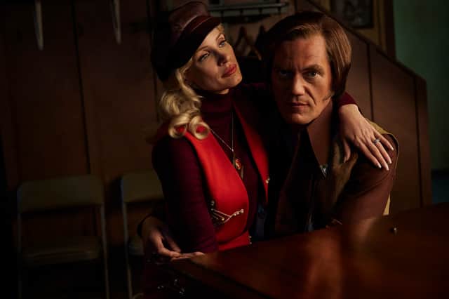 Jessica Chastain as Tammy Wynette and Michael Shannon as George Jones, sat together at a piano in George and Tammy (Credit: Dana Hawley/Paramount+)