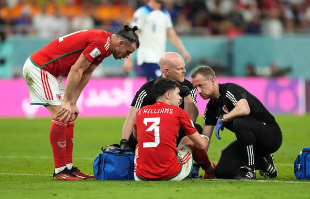 Wales Neco Williams receives treatment before leaving the pitch as a suspected concussion substitute during the FIFA World Cup Group B match at the Ahmad Bin Ali Stadium, Al Rayyan, Qatar. (Photo: PA)