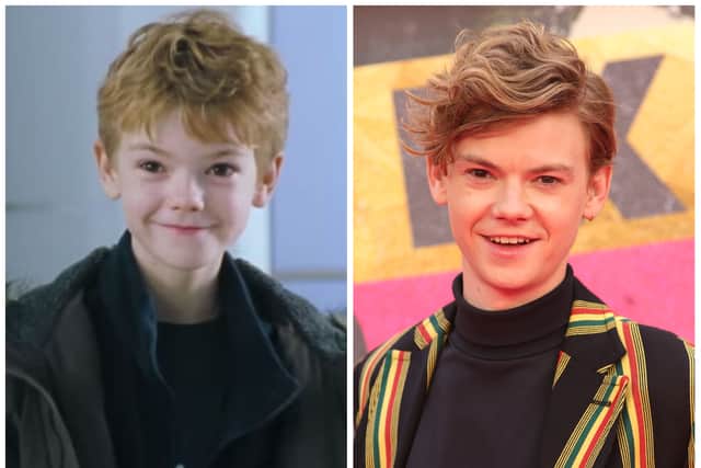 Thomas Brodie-Sangster as Sam in Love Actually in 2003; Thomas Brodie-Sangster at the Pistol premiere in 2022 (Credit: Universal; Lia Toby/Getty Images)