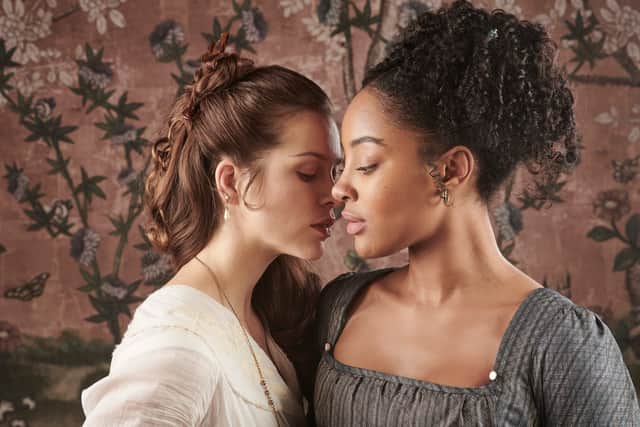 Karla Simone-Spence as Frannie and Sophie Cookson as Madame Benham in The Confessions Of Frannie Langton, leaning in to embrace one another (Credit: Drama Republic/ITVX)