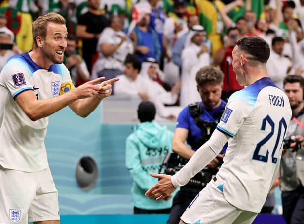 Kane celebrates with Phil Foden after scoring England’s second goal against Senegal
