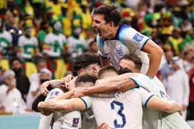 Harry Maguire of England celebrates with team mates after his captain Harry Kane of England scores their teams second goal during the FIFA World Cup Qatar 