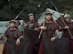 Ryan Sampson as Grumio,Tom Basden as Aurelius, Tom Rosenthal as Marcus, and Jonathan Pointing as Jason in Plebs: Soldiers of Rome, all wearing centurion armour (Credit: ITVX/Rise Films)