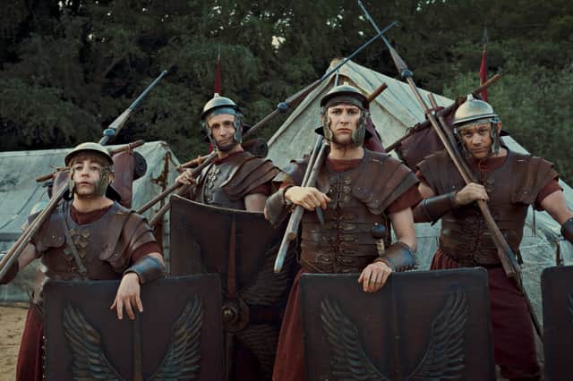 Ryan Sampson as Grumio,Tom Basden as Aurelius, Tom Rosenthal as Marcus, and Jonathan Pointing as Jason in Plebs: Soldiers of Rome, all wearing centurion armour (Credit: ITVX/Rise Films)