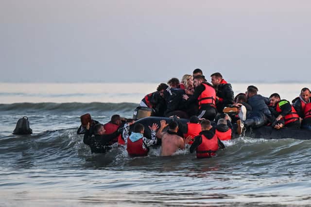 About forty migrants, from various origins, board an inflatable boat before they attempt to cross the Channel to Britain. Credit: Getty Images