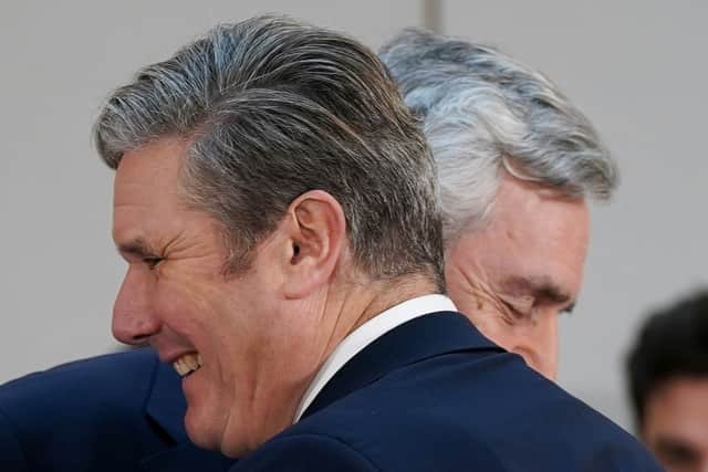 Labour leader Sir Keir Starmer and former Labour Prime Minister, Gordon Brown (R) exchange a greeting during a press conference on The Commission on the UK’s Future report on December 05, 2022 in Leeds, England. (Photo by Ian Forsyth/Getty Images)