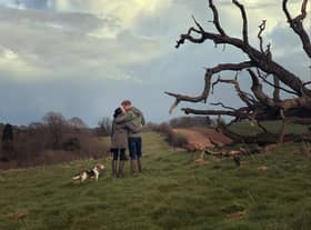 Harry, Meghan, and their dog, next to a tree, shot from behind from a short distance away (Credit: Netflix)