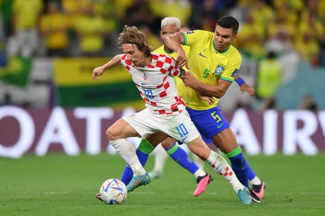 Luka Modric holds off Brazil’s Casemiro in World Cup quarter-final