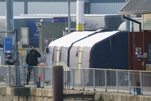 Forensic tents erected at the RNLI station at the Port of Dover following a large search and rescue operation launched in the Channel off the coast of Dungeness, in Kent. Credit: PA