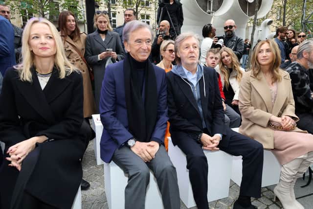 Bernard Arnault and daughter Delphine (left) with Paul McCartney and wife Nancy Shevell at the Stella McCartney Womenswear Spring/Summer 2023 show in Paris. Photo by ERIC PIERMONT/AFP via Getty Images)
