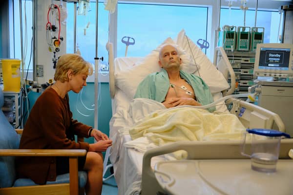 Margarita Levieva as Marina Litvinenko with David Tennant as Alexander Litvinenko in Litvinenko. He is in his hospital bed, and she sits beside him, looking nervous (Credit: ITVX)