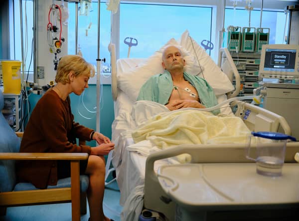 Margarita Levieva as Marina Litvinenko with David Tennant as Alexander Litvinenko in Litvinenko. He is in his hospital bed, and she sits beside him, looking nervous (Credit: ITVX)