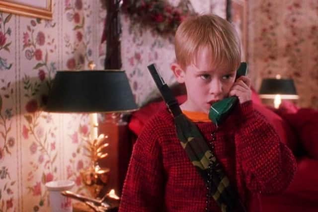 Macauley Culkin in Home Alone (1990) as he defends his family home against burglars. 