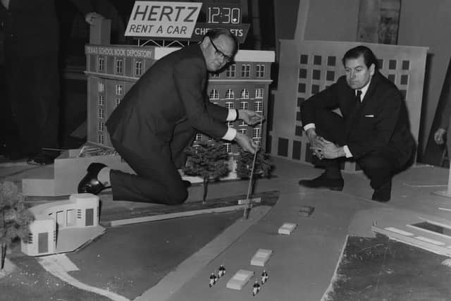 Cliff Michelmore pointing to the path of gun shots which killed President John F Kennedy, on a model reconstruction (Photo: Getty Images)