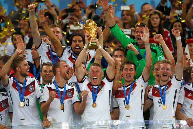Bastian Schweinsteiger of Germany lifts the World Cup trophy with teammates. (Getty Images)