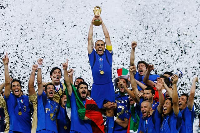 The Italian players celebrate as Fabio Cannavaro of Italy lifts the World Cup trophy. (Getty Images)