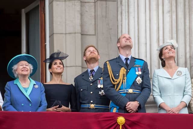 Queen Elizabeth II, Meghan, Duchess of Sussex, Prince Harry, Duke of Sussex, Prince William, Duke of Cambridge and Catherine, Duchess of Cambridge watch the RAF flypast on the balcony of Buckingham Palace, as members of the Royal Family attend events to mark the centenary of the RAF on July 10, 2018 in London, England. (Photo by Paul Grover - WPA Pool/Getty Images)
