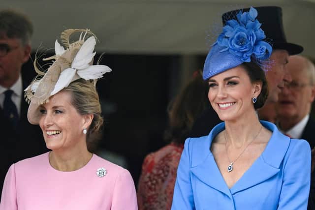 Kate Middleton with Sophie, Countess of Wessex. How chic is Kate's blue Alexander McQueen dress? (Photo by TOBY MELVILLE/POOL/AFP via Getty Images)