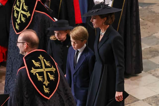 Kate Middleton wore a black Alexander McQueen coat dress to the state funeral of Queen Elizabeth 11.  (Photo by PHIL NOBLE/POOL/AFP via Getty Images)