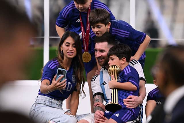 Argentina's captain and forward #10 Lionel Messi, his wife Antonela Roccuzzo (L) and children Thiago (topR), Ciro and Mateo pose with the FIFA World Cup Trophy after Argentina won the Qatar 2022 World Cup final football match between Argentina and France at Lusail Stadium in Lusail, north of Doha on December 18, 2022. (Photo by Kirill KUDRYAVTSEV / AFP) (Photo by KIRILL KUDRYAVTSEV/AFP via Getty Images)