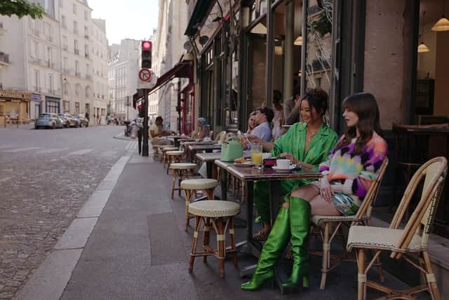 Emily in Paris. (L to R) Ashley Park as Mindy, Lily Collins as Emily in season 3 (Photo: Netflix)