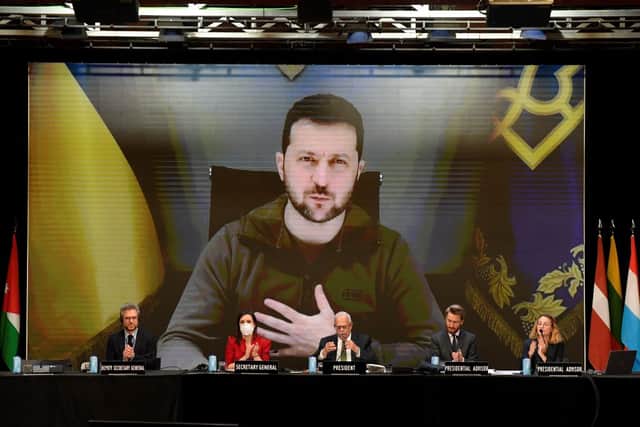 Ukrainian President Volodymyr Zelensky is seen on a giant screen as he delivers a speech during NATO Parliamentary Assembly annual session held in Madrid on November 21, 2022. (Photo by OSCAR DEL POZO / AFP) (Photo by OSCAR DEL POZO/AFP via Getty Images)