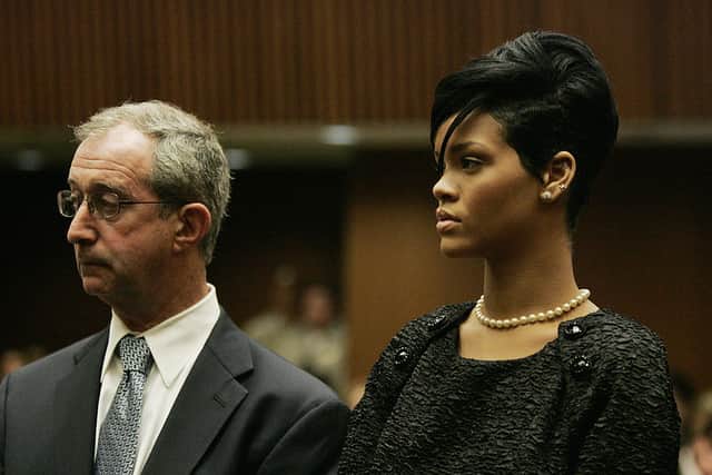 Lawyer Donald Etra (L) stands with singer Rihanna inside the Los Angeles Superior Court during the hearing in the Chris Brown felony assault case on June 22, 2009. R&B singer Chris Brown has pleaded guilty to assaulting former girlfriend Rihanna and will be sentenced to 180 days of community labor for the attack, lawyers said June 22, 2009 (Photo credit: Lori SHEPLER/AFP via Getty Images)