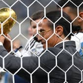 Nusret Goekce, nicknamed Salt Bae, admires the FIFA World Cup Qatar 2022 Winner’s Trophy (Getty Images)