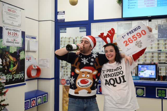 Pablo Nogales and his wife Paloma Rodriguez celebrate selling the winning ticket of the biggest prize during the draw of Spain’s Christmas lottery on December 22, 2019. (Photo by CRISTINA QUICLER/AFP via Getty Images)