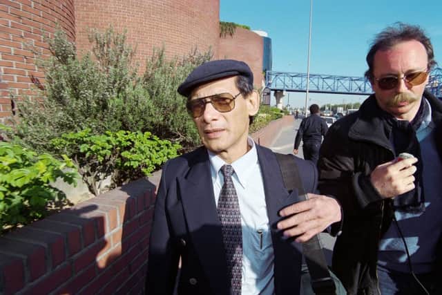 French serial killer, fraudster, and thief Charles Sobhraj (C) leaves the court in Paris on April 8, 1997 (Photo by JACK GUEZ/AFP via Getty Images)
