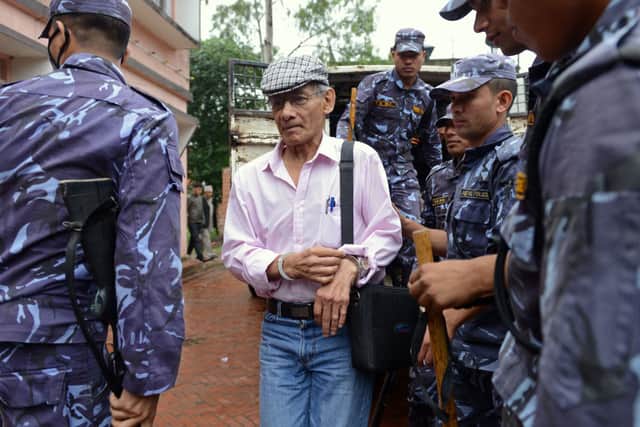 French serial killer Charles Sobhraj (C) is brought to the district court for a hearing on a case related to the murder of Canadian backpacker Laurent Ormond Carriere, in Bhaktapur on May 26, 2014 (Photo by PRAKASH MATHEMA/AFP via Getty Images)