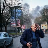 An injured man stands on a street after Russian shelling to Ukrainian city of Kherson on December 24. Credit: DIMITAR DILKOFF/AFP via Getty Images