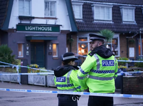 Police officers on duty at the Lighthouse Inn in Wallasey Village, near Liverpool, after a woman died and multiple people were injured in a shooting incident on Christmas Eve. Credit: PA