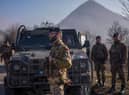 Italian soldiers serving in a NATO-led international peacekeeping mission in Kosovo patrol near a road barricaded with trucks by Serbs in the village of Rudare (AFP via Getty Images)