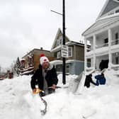 Luke Bennett helps to clear heavy snow for his neighbours in Buffalo, New York on 27 December 2022 (Photo: John Normile/Getty Images)