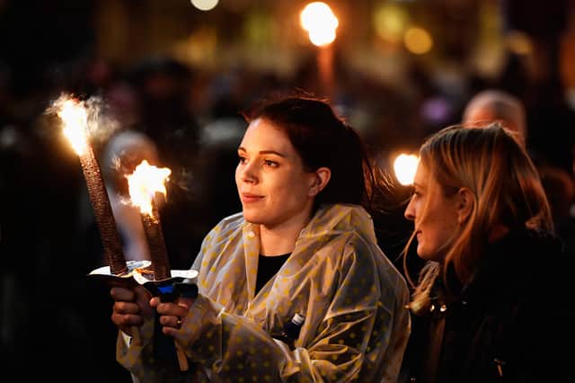 EDINBURGH, SCOTLAND - DECEMBER 30:  Members of the public take part during the torchlight procession as it makes its way through Edinburgh for the start of the Hogmanay celebrations on December 30, 2016 in Edinburgh, Scotland. It is expected to bring in 150,000 visitors from more than 80 countries to the city for the traditional New Year celebrations, which run over three days.  (Photo by Jeff J Mitchell/Getty Images)