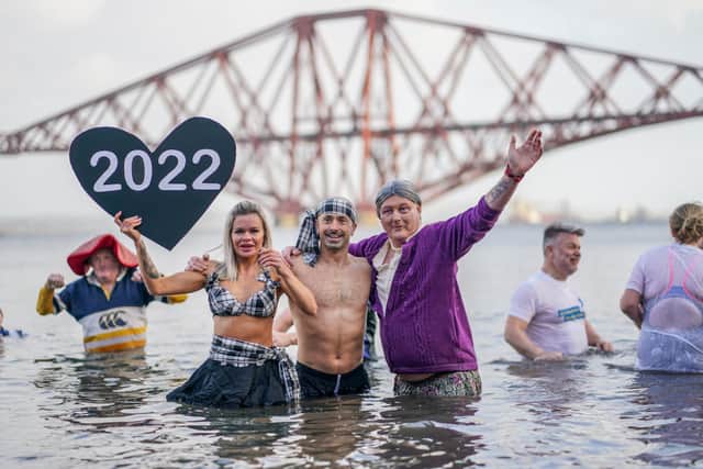 Members of the public brave cold waters in River Forth to take a New Year dip in front of the Forth Rail Bridge on January 1, 2022 in South Queensferry, Scotland. COVID restrictions prevented the official Loony Dook from taking place however locals still turned out for the annual New Years Day event. (Photo by Peter Summers/Getty Images)