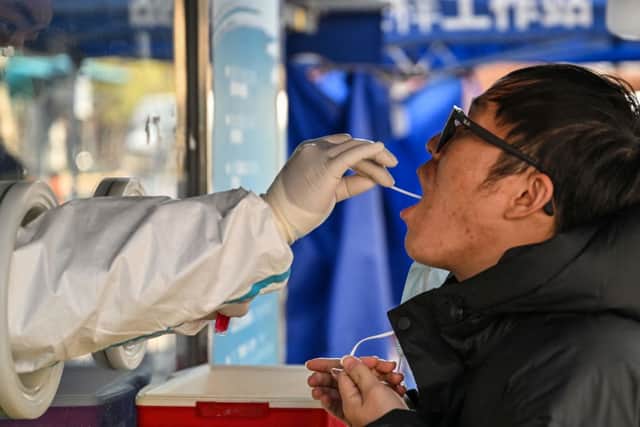 Chinese visitors to England will require a negative Covid test from January. Credit: HECTOR RETAMAL/AFP via Getty Images