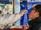 Chinese visitors to England will require a negative Covid test from January. Credit: HECTOR RETAMAL/AFP via Getty Images